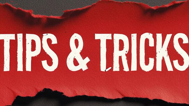 Stop motion animation of burning paper revealing the text tips and tricks. Red banner with torn edges crumbling and dissolving on a dark surface