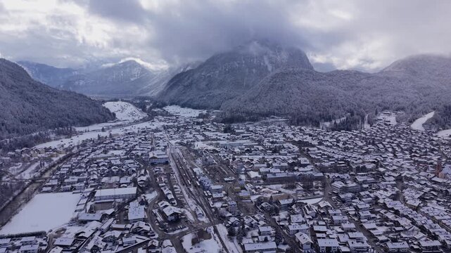 Snowy peaks of Noerdliche Karwendelkette. Drone video of Mittenwald, Germany. Luftbild vom Luftkurort im Landkreis Garmisch-Partenkirchen. Rugged rocks and winter forest in the Bavarian Alps.