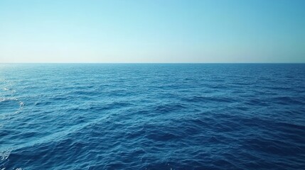 Obraz premium Vast expanse of calm ocean, clear blue sky