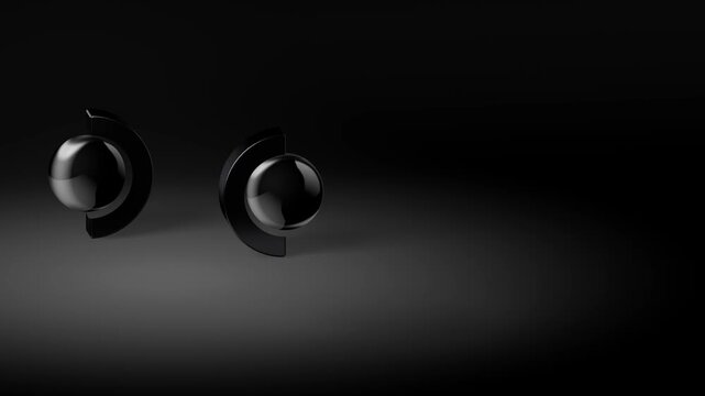 Two black spheres cradled in crescent stands positioned on a dark minimalist background representing partnership and collaborative innovation in a modern world