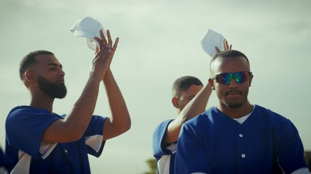 Baseball team celebrates with enthusiastic applause with caps in their hands