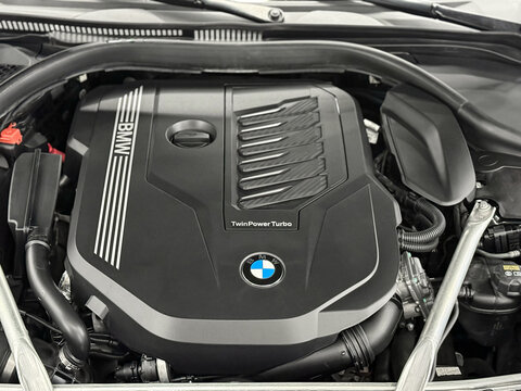 Twin Power Turbo gasoline engine. BMW sport engine or motor under vehicle hood. BMW 8 II (G14, G15, G16) detail of new car engine. Engine motor of BMW car close-up with emblem.