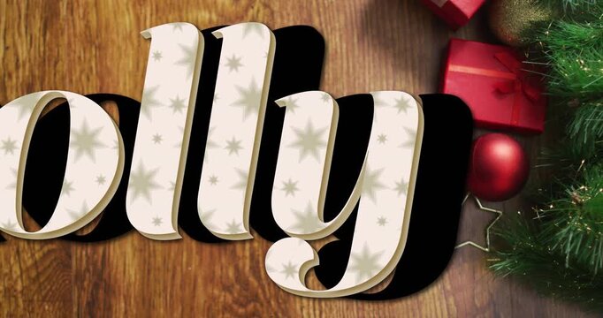 Animation of holly text over christmas gifts and decorations on wooden surface with copy space