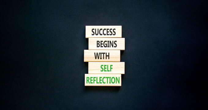 Self reflection symbol. Concept words Success begins with self reflection on beautiful wooden blocks. Beautiful black paper background. Business success begins with self reflection concept. Copy space