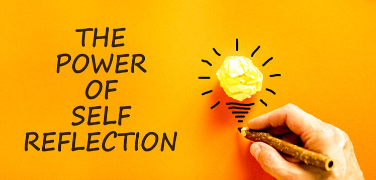 Self reflection symbol. Concept words The power of self reflection on beautiful orange paper. Beautiful orange background. Businessman's hand. Business the power of self reflection concept. Copy space