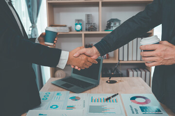 Businesspeople or lawyers shake hands after a meeting, signifying the success of the negotiations and the handshake. (Close-up shot)