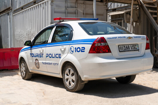 Tashkent (Toshkent), Uzbekistan (O'zbekiston) - May 26, 2025: A white Tourist Police car parked near a construction site at the historic Khazrati Imam complex.