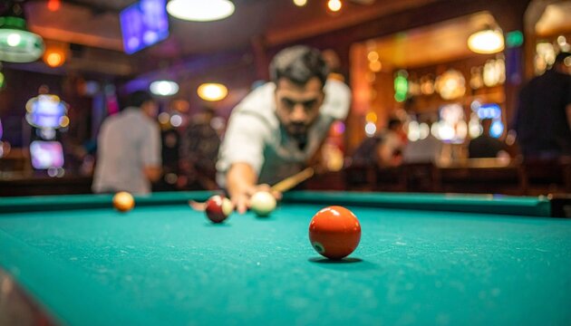 Man plays pool in a crowded bar with balls on green table