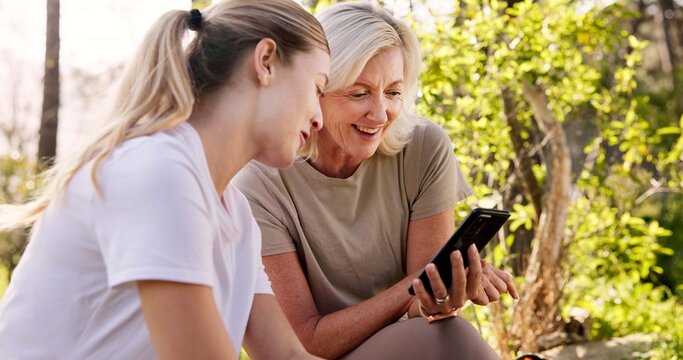Mother, adult daughter and outdoor with smartphone, smile or fitness with vacation, bonding together and network. Nature, family or joy with mama, cellphone and woods with digital app or social media