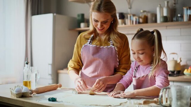 Cheerful family making dough at home closeup. Smiling mother child having fun