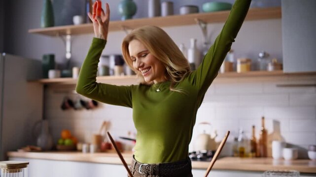 Carefree girl preparing food dancing favourite song home closeup. Joyful woman