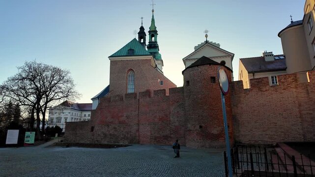 Baszta Dorotka in Kalisz &ndash; historic defensive tower and city walls fragment, tourist attraction on the Piast Route, medieval fortification architecture near St. Joseph's Basilica Treasury on a sunny d