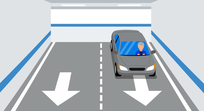 Car driving in a tunnel with directional arrows on the road