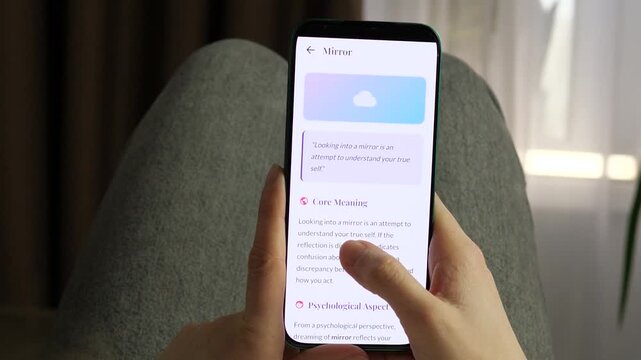Person using a mobile dream dictionary app for self-discovery. High-quality POV shot of a mobile dream dictionary. User interacts with symbols like hair, house, and mirror to find core meanings. Great