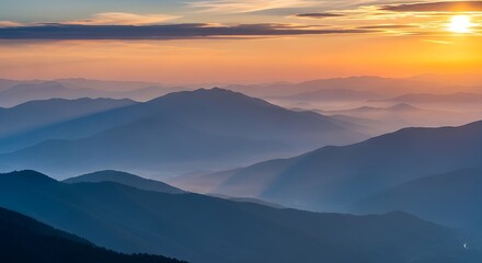 Obraz premium A mountain range with a sunset in the background