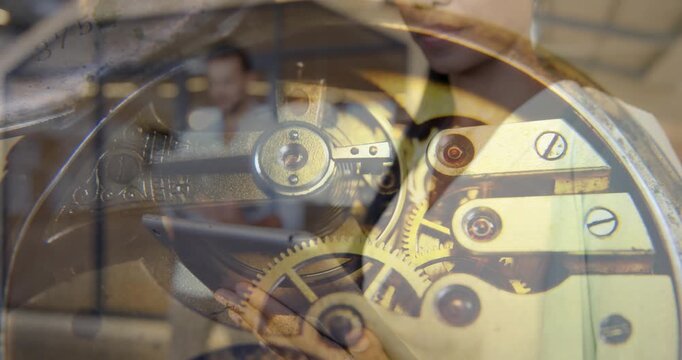 Composite video of watch mechanism against african american woman using digital tablet at office