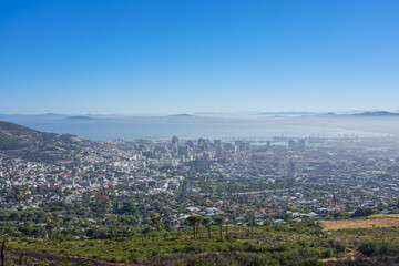 Obraz premium South Africa,Cape Town,Table Mountain,Panoramic view of a coastal city surrounded by hills and ocean under clear blue sky