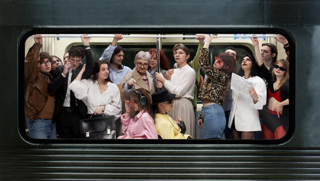 Diverse group of passengers standing crowded inside subway train holding overhead rail in urban environment. Concept of daily commute, public transport, city lifestyle and rush hour crowd.