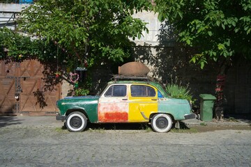 Fototapeta premium Bright colorful car parked on sunny summer day