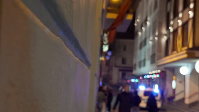 Urgent scene captured on bustling city street. Vibrant city nightlife scene featuring first responders and tense realtime footage