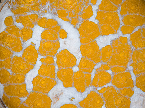 Aerial view of a mesmerizing mosaic of golden hues fractured by veins of stark white, creating an abstract landscape that captivates the eye., Avezzano, Abruzzo, Italy.