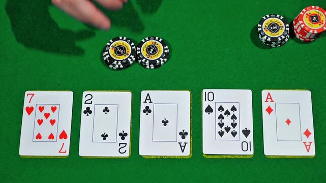 Poker action with three cards in frame as dealer reveals fourth and fifth cards and player places bets