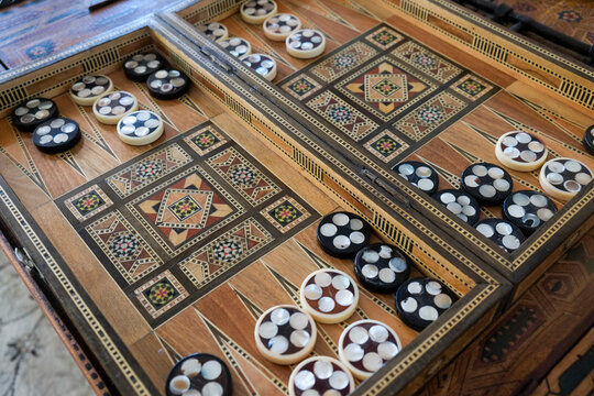Fes, Morocco.  Traditional Moroccan backgammon board with decorative wood inlay and game pieces