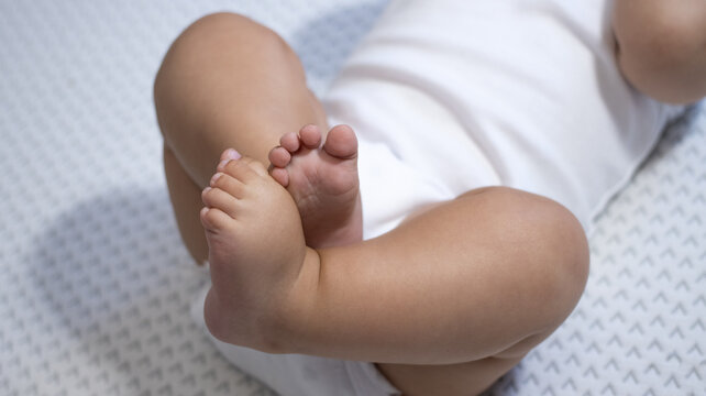 A cozy shot capturing the adorable baby feet, showcasing their chubby toes and soft skin in a peaceful