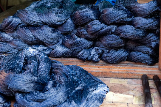 Fes, Morocco  Pile of freshly indigo dyed silk fabric i