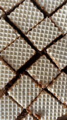 Fototapeta premium Wafer cookies texture with caramel filling, abstract food background pattern