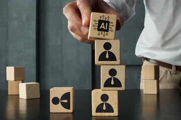 Artificial intelligence replacing workforce concept with wooden blocks showing AI symbol on top of human figures, automation, job displacement, technology impact on employment and business