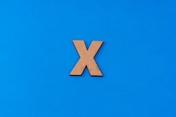Obraz premium Letter X on paper on a blue background