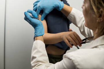 Obraz premium Focus on the injector pen interface as a medical professional applies a dose to a patient's arm.