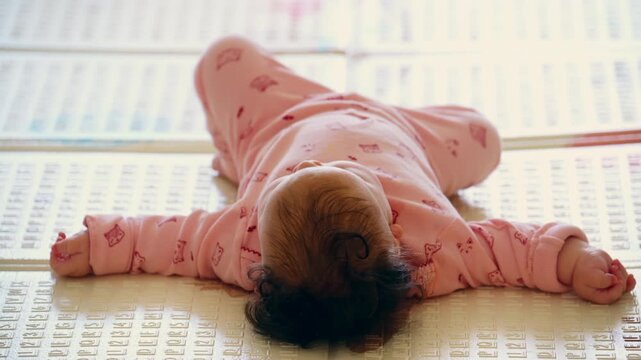 Infant lying comfortably on a soft educational play mat indoors