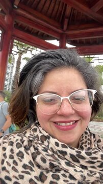 Young woman recording selfie vlog during travel adventure UGC