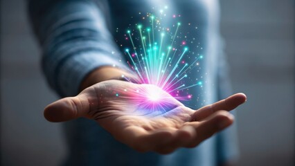 Fototapeta premium A person holding a glowing, colorful burst of light and digital particles in their open palm, symbolizing technology and innovation.