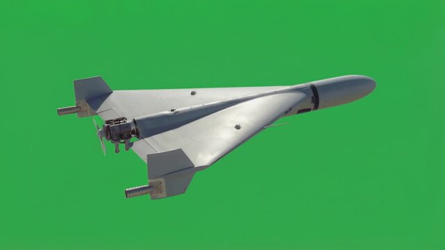 Delta wing kamikaze drone flying against green screen background. Unmanned attack aircraft with rear propeller and grey fuselage for military operations. Static wide shot.