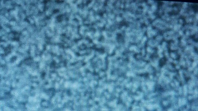 Old television screen turning on and off displaying static noise and interference with a flickering effect