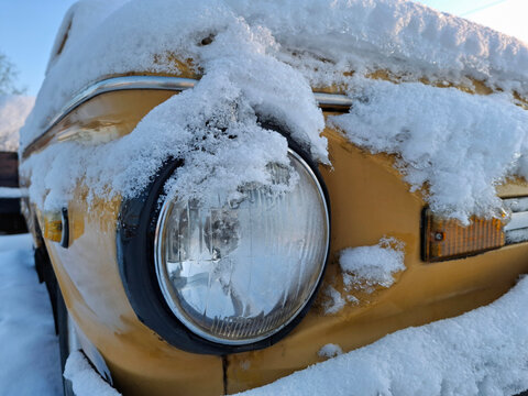 The yellow vehicle looks striking in the snowy winter scene