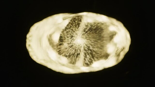 Close-up of a rotating diamond with sparkling facets and light reflections