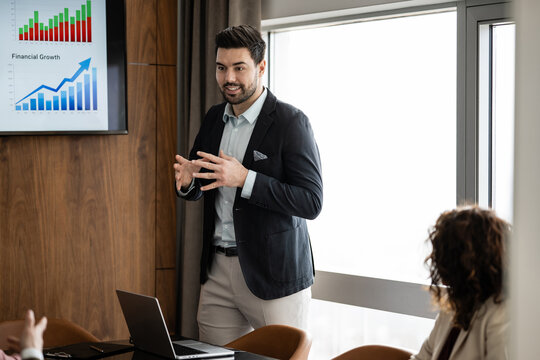 Businessman presenting financial growth data in meeting