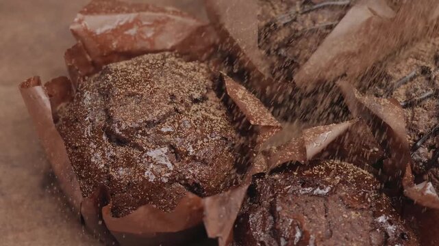Dusting Cocoa Powder on Fresh Chocolate Muffins