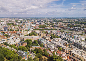 Obraz premium Bristol England: 28th July 2025: Drone view of Bristol Harbourside, surrounded by historic buildings along the River Avon with city in background