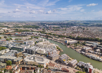 Fototapeta premium Bristol England: 28th July 2025: Drone view of Bristol Harbourside, surrounded by historic buildings along the River Avon with city in background