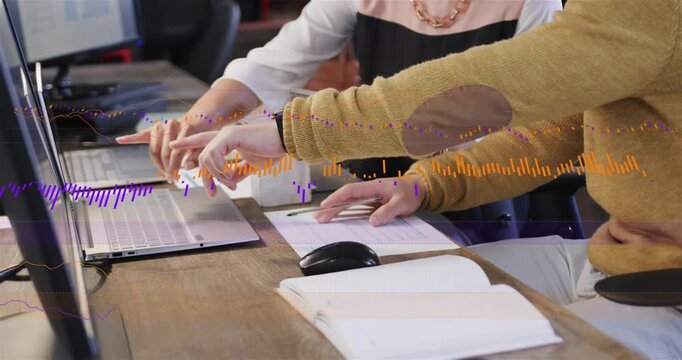 Woman pointing tablet as man typing on laptop causing color waveform graphs and analyzing business
