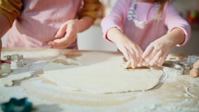 Focused family making cookies at table closeup. Mother daughter preparing food