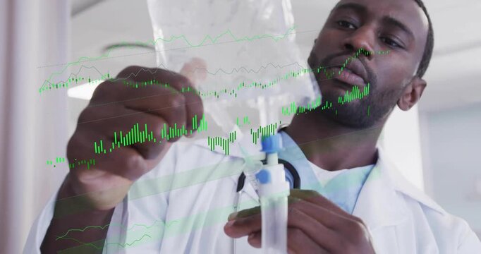 Male doctor holding IV bag priming tubing adjusting clamp ensuring flow monitoring waveform overlay