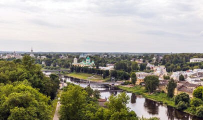 Fototapeta premium Idyllic aerial city view of Torzhok, Russia showcasing lush greenery, calm river, and distinct historical architecture in a serene atmosphere