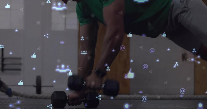 Man placing hands on DBs, starting plank for fitness, shifting grip, social icons drifting over him