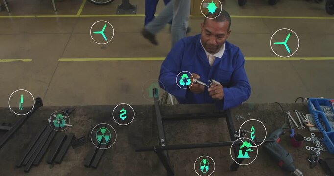 Tech reaching for left pile, building frame, securing bolts for factory with green icons around